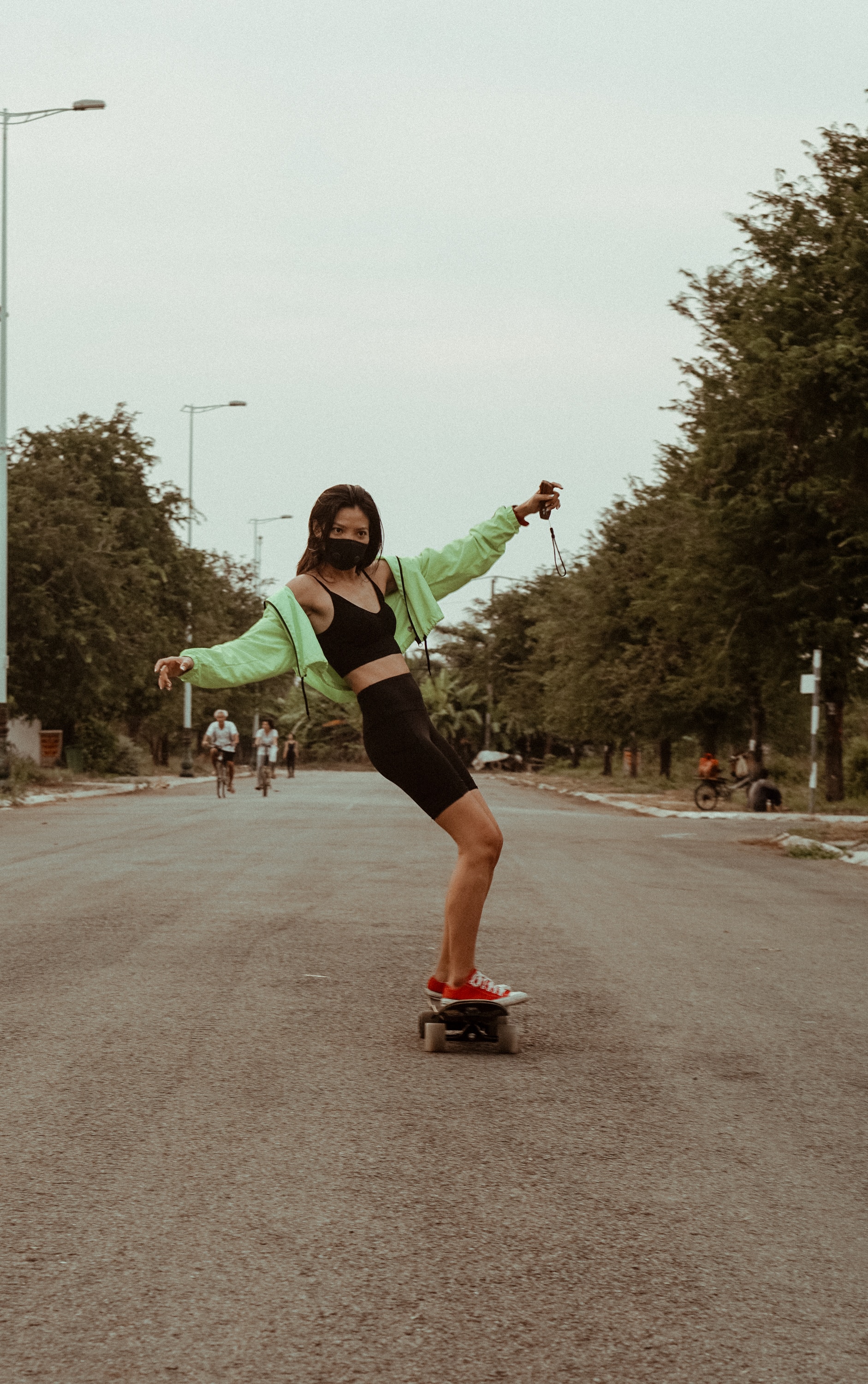 Female skater in a face mask skates the streets of Ho Chi Minh.